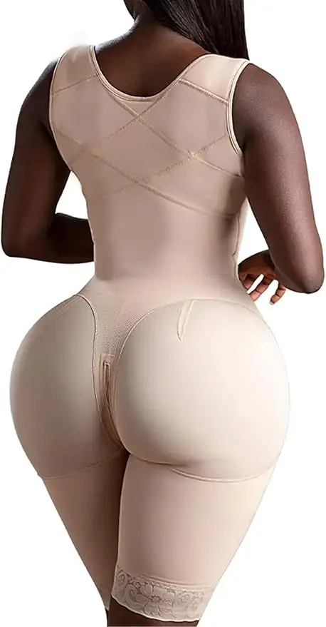 A woman is shown from the back wearing a beige full-body shapewear garment that covers her torso and extends to mid-thighs. Ideal for post-liposuction Dallas recovery, the shapewear features lace-trimmed legs and a seamless design.